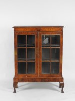 Lot 140 - An 18th century style walnut veneered bookcase...