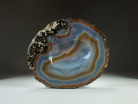 Lot 17 - A banded agate polished geode slice, dished to...