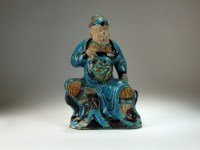Lot 93 - A Chinese sancai glazed figure of a guardian,...