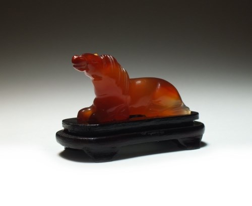 Lot 164 - A Chinese carved carnelian figure of a horse,...