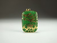 Lot 167 - A Chinese jadeite and yellow metal pendant,...