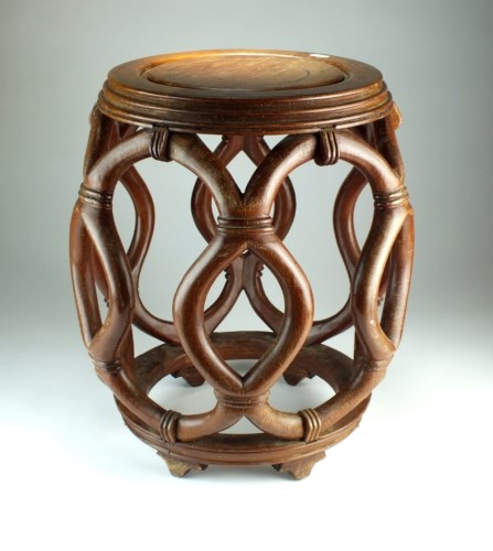 Lot 289 - A Chinese hardwood barrel stool, the moulded...
