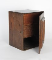 Lot 89 - An early 19th century oak cabinet, the single...