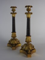 Lot 96 - A pair of Charles X gilt metal candlesticks...