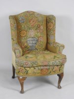 Lot 116 - A 19th century winged armchair in the George I...