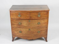 Lot 124 - A small Regency bowfront mahogany chest of two...