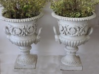 Lot 374 - A pair and one single campana shaped cast iron...