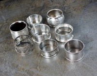 Lot 102 - Five silver napkin rings, various dates and...