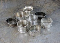 Lot 103 - A collection of eight silver napkin rings,...