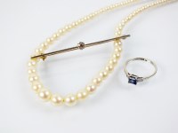 Lot 151 - A three stone sapphire and diamond ring,...