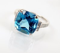 Lot 169 - An 18ct white gold topaz and diamond ring,...