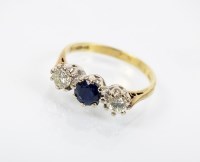 Lot 170 - An 18ct gold three stone sapphire and diamond...