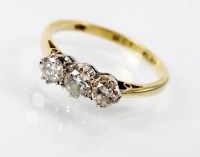 Lot 187 - A three stone diamond ring, designed as three...