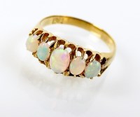 Lot 194 - A graduated five stone opal ring, the oval...