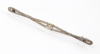 Lot 216 - A diamond bar brooch, designed as a central...
