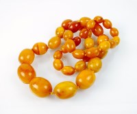 Lot 226 - A graduated amber bead necklace, comprising...