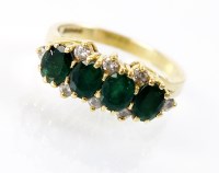 Lot 254 - An 18ct gold twelve stone emerald and diamond...