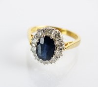 Lot 85 - An 18ct gold sapphire and diamond oval cluster...