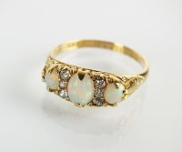 Lot 86 - An Edwardian nine stone opal and diamond ring,...