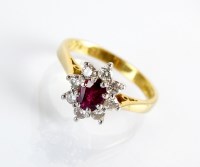 Lot 87 - An 18ct gold ruby and diamond oval cluster...