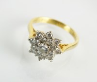 Lot 89 - An 18ct gold graduated diamond cluster ring,...