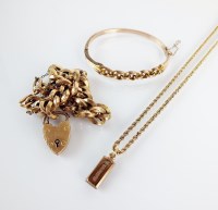 Lot 94 - A 9ct gold ingot pendant, suspended on 9ct...