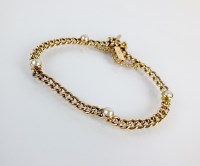 Lot 104 - A split seed pearl set bracelet, designed as...