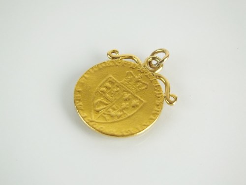 Lot 112 - A spade guinea pendant with scroll mount,...