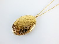 Lot 120 - A 9ct gold oval locket, with bright cut...