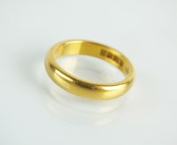 Lot 129 - A 22ct gold plain polished wedding band, ring...