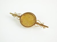 Lot 138 - A half sovereign set bar brooch, dated 1910,...