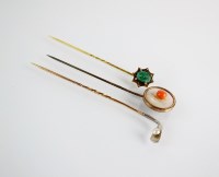 Lot 144 - A novelty seed pearl set stick pin in the form...