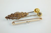 Lot 145 - A single stone diamond bar brooch, together...