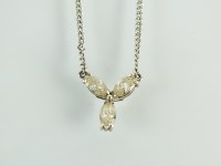 Lot 164 - A three stone diamond floral pendant, designed...