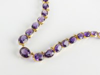 Lot 181 - A late 19th century amethyst riviere necklace,...