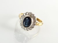 Lot 184 - An 18ct gold sapphire and diamond cluster ring,...