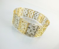 Lot 200 - A yellow and white metal panel bracelet,...