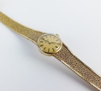 Lot 230 - A Lady's 9ct gold Omega bracelet watch, the...