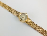 Lot 243 - A Lady's 18ct gold Omega bracelet watch, the...