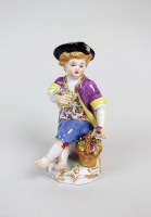 Lot 13 - A Meissen porcelain figure of a seated child,...