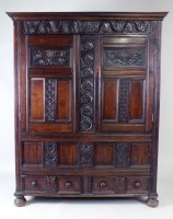 Lot 208 - A carved and joined oak livery cupboard dated...