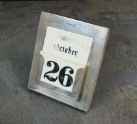 Lot 26 - A silver mounted desk calendar, Walker & Hall,...