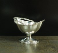 Lot 79 - A George III silver swing handled sugar basket,...