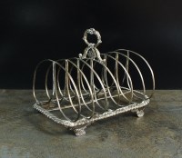 Lot 80 - A William IV silver six division toast rack,...