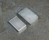 Lot 115 - Two white metal engine turned pill boxes, both...