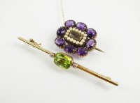 Lot 171 - A peridot and diamond bar brooch, designed as...