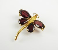 Lot 172 - A garnet and white sapphire set dragonfly...