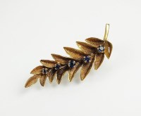 Lot 183 - A 9ct gold sapphire set leaf brooch, designed...