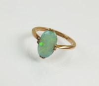 Lot 185 - A 9ct gold single stone opal ring, the oval...