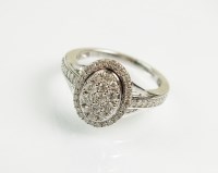 Lot 193 - A 9ct white gold diamond cluster ring,...